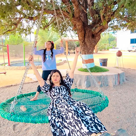 Women enjoying giant swing ride at Go Ranch Resort near Hyderabad